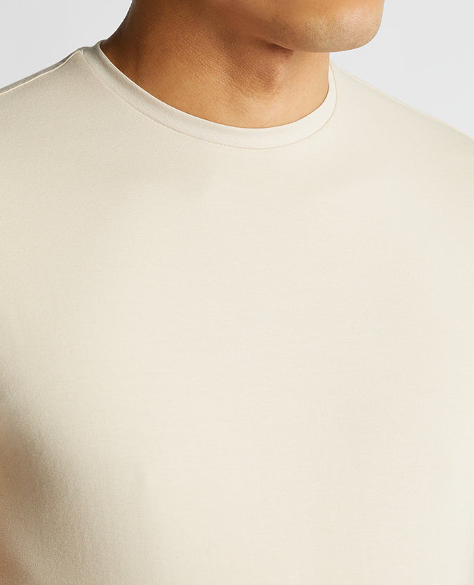 Man wearing a sand Tapered Fit Cotton-Stretch T-Shirt