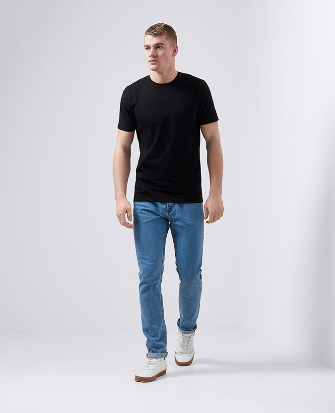 Man wearing a black Tapered Fit Cotton-Stretch T-Shirt