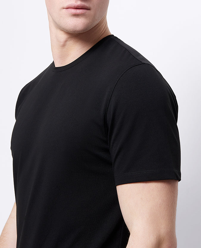 Man wearing a black Tapered Fit Cotton-Stretch T-Shirt
