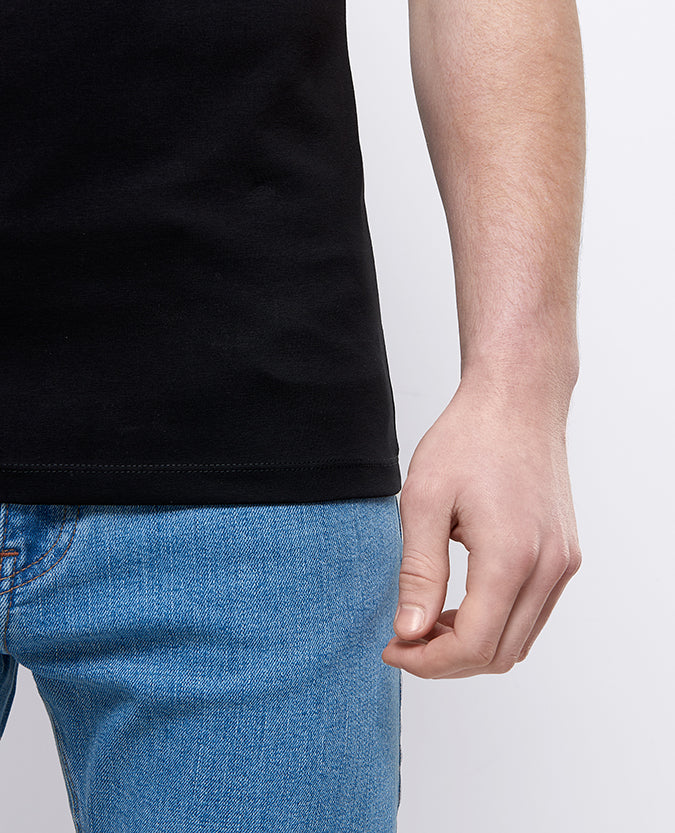 Man wearing a black Tapered Fit Cotton-Stretch T-Shirt