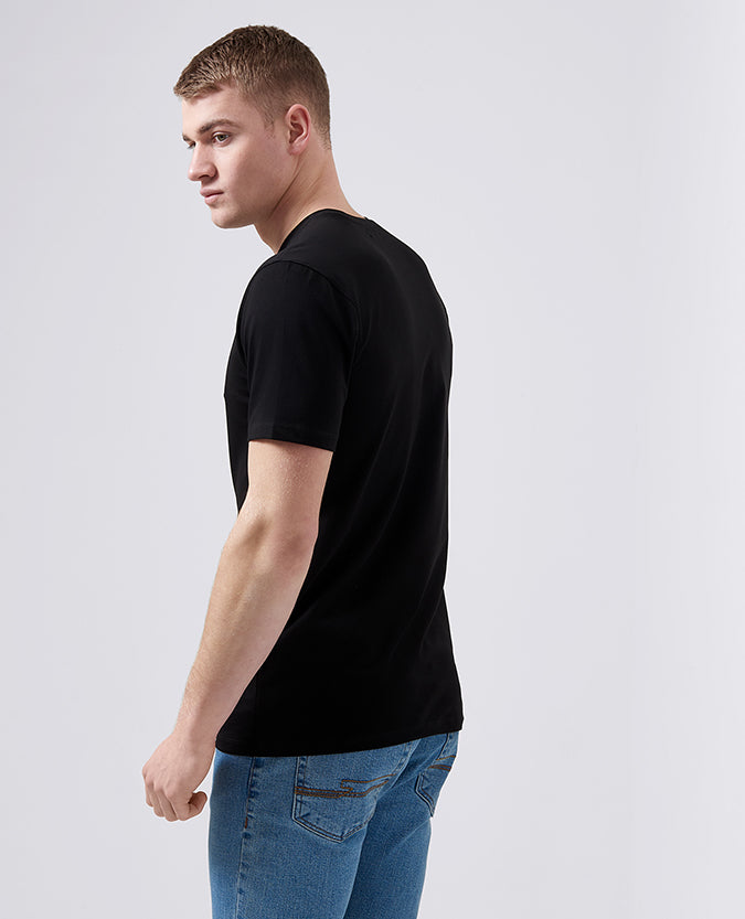 Man wearing a black Tapered Fit Cotton-Stretch T-Shirt