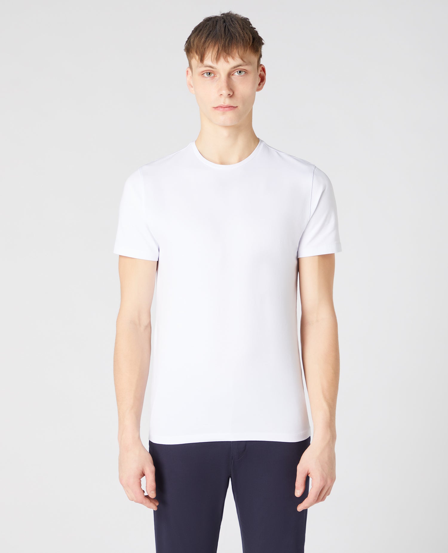 Man wearing a white Tapered Fit Cotton-Stretch T-Shirt