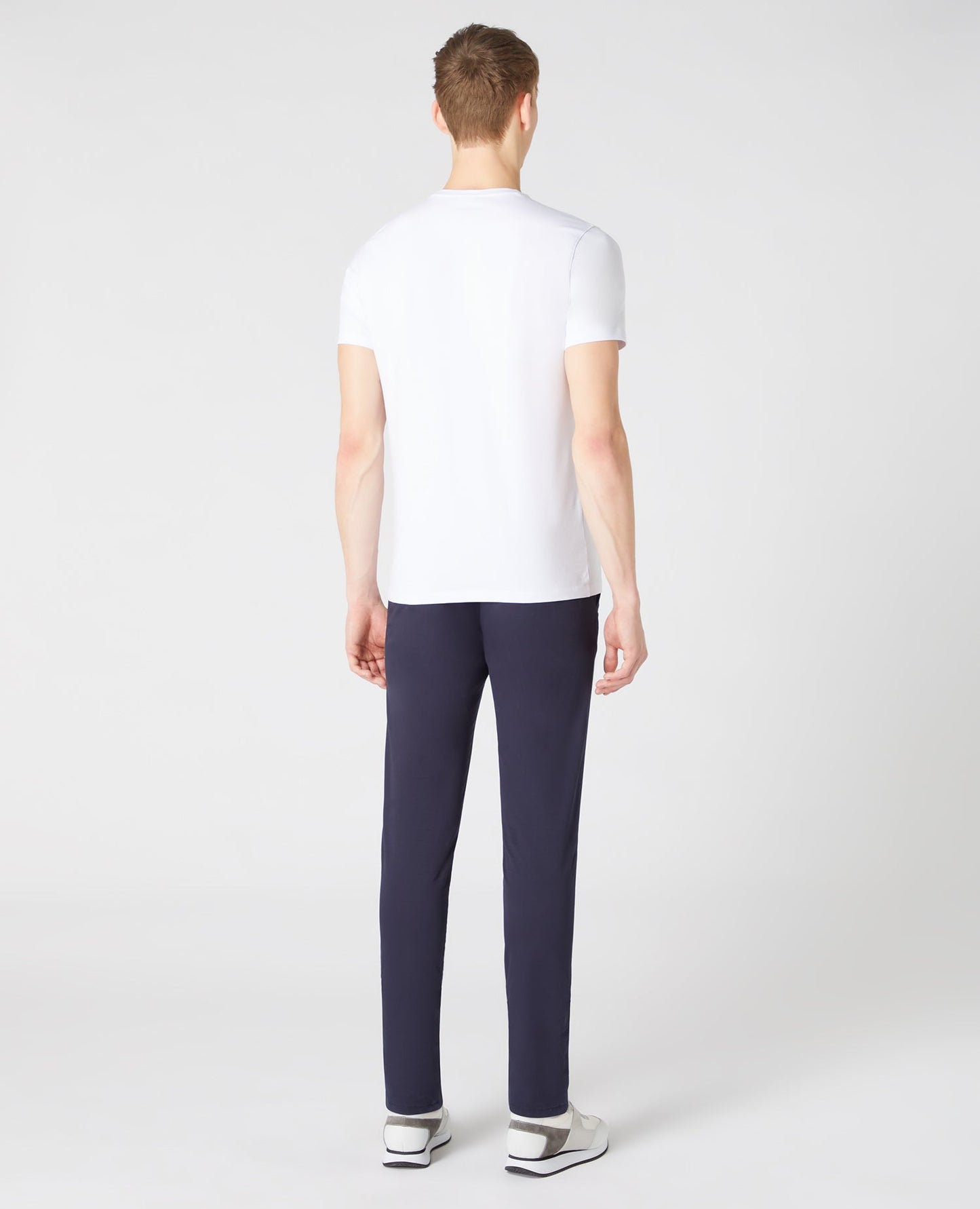 Man wearing a white Tapered Fit Cotton-Stretch T-Shirt