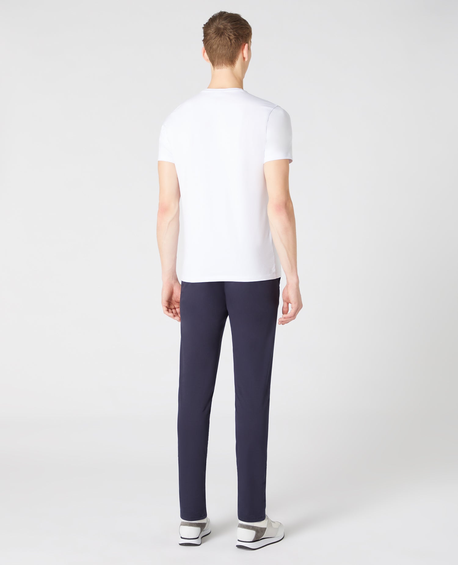 Man wearing a white Tapered Fit Cotton-Stretch T-Shirt