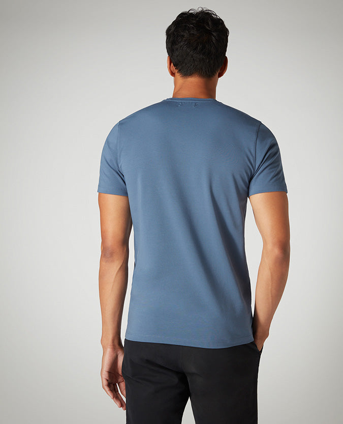 Man wearing a blue Tapered Fit Cotton-Stretch T-Shirt