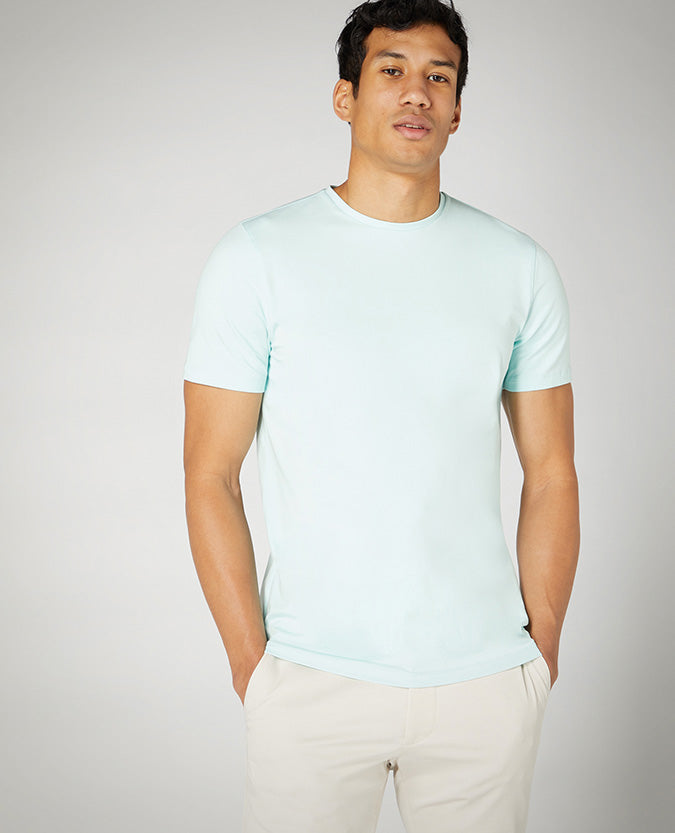 Man wearing a green Tapered Fit Cotton-Stretch T-Shirt