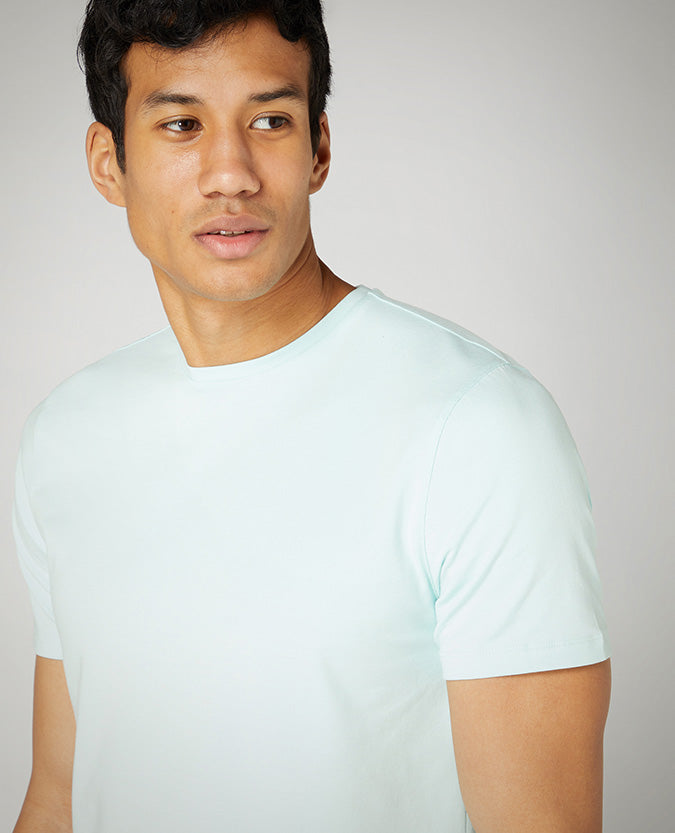 Man wearing a green Tapered Fit Cotton-Stretch T-Shirt