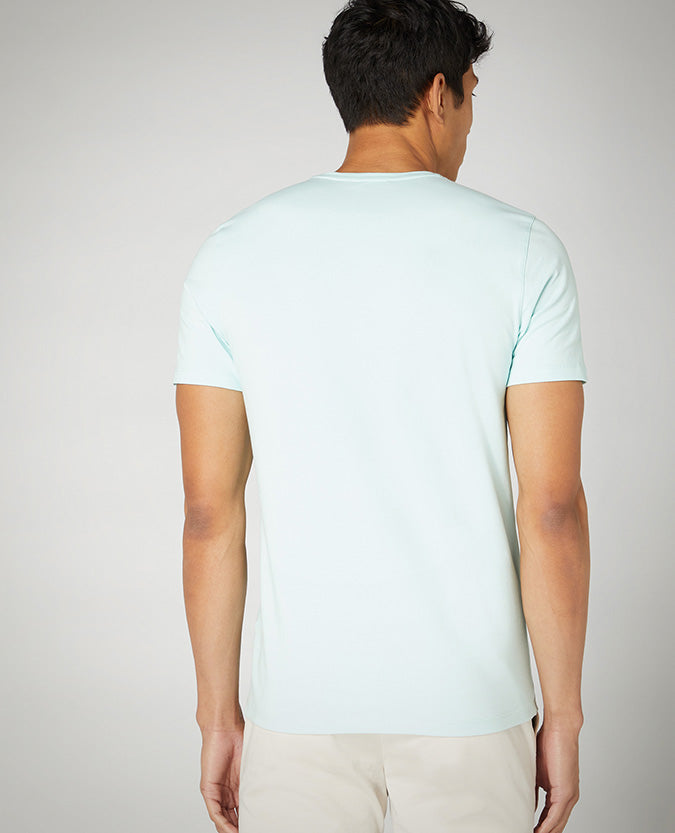 Man wearing a green Tapered Fit Cotton-Stretch T-Shirt