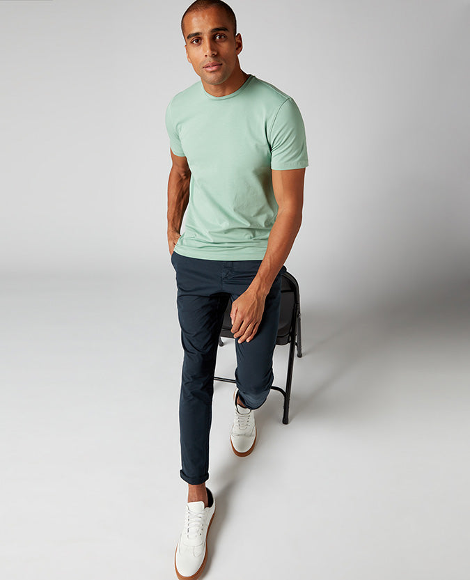 Man wearing a green Tapered Fit Cotton-Stretch T-Shirt