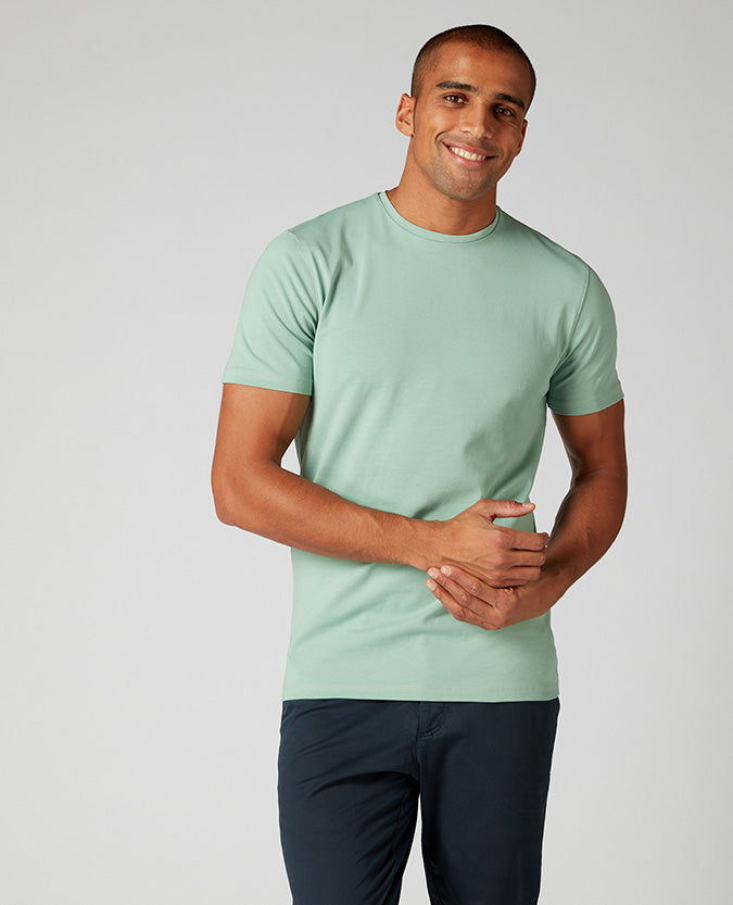 Man wearing a green Tapered Fit Cotton-Stretch T-Shirt