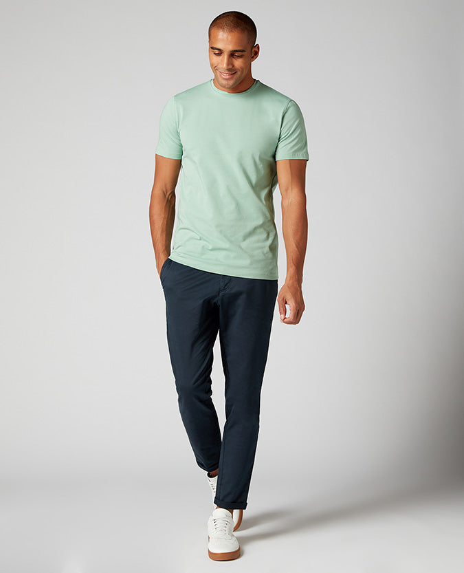 Man wearing a green Tapered Fit Cotton-Stretch T-Shirt