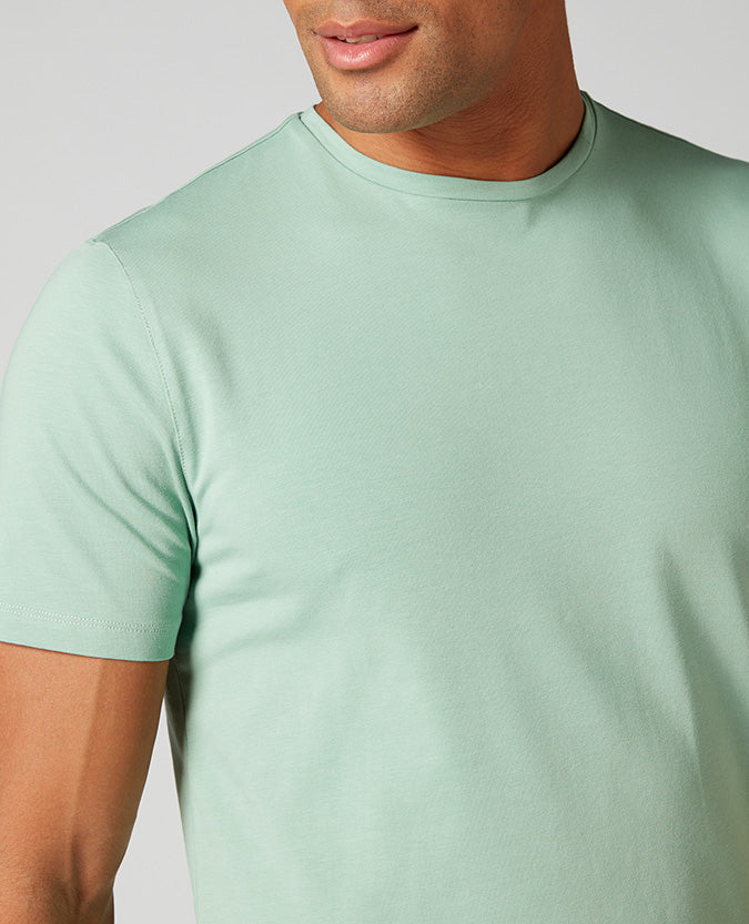 Man wearing a green Tapered Fit Cotton-Stretch T-Shirt