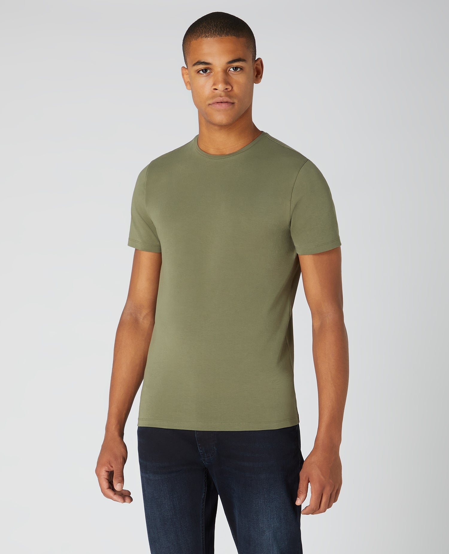 Man wearing a green Tapered Fit Cotton-Stretch T-Shirt