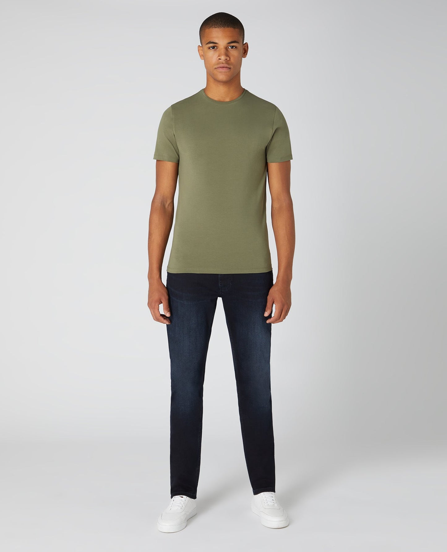 Man wearing a green Tapered Fit Cotton-Stretch T-Shirt