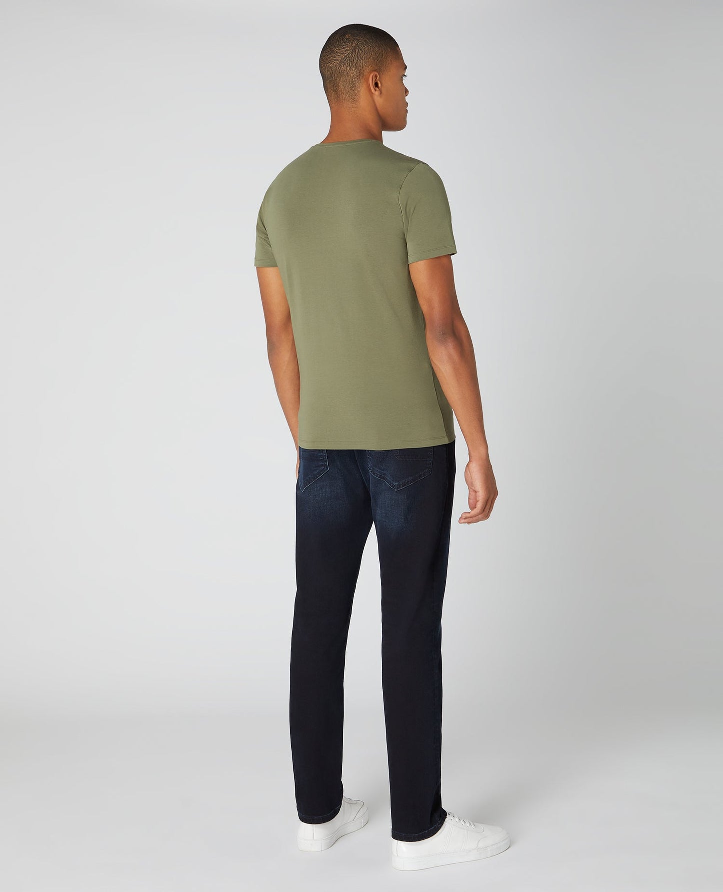Man wearing a green Tapered Fit Cotton-Stretch T-Shirt