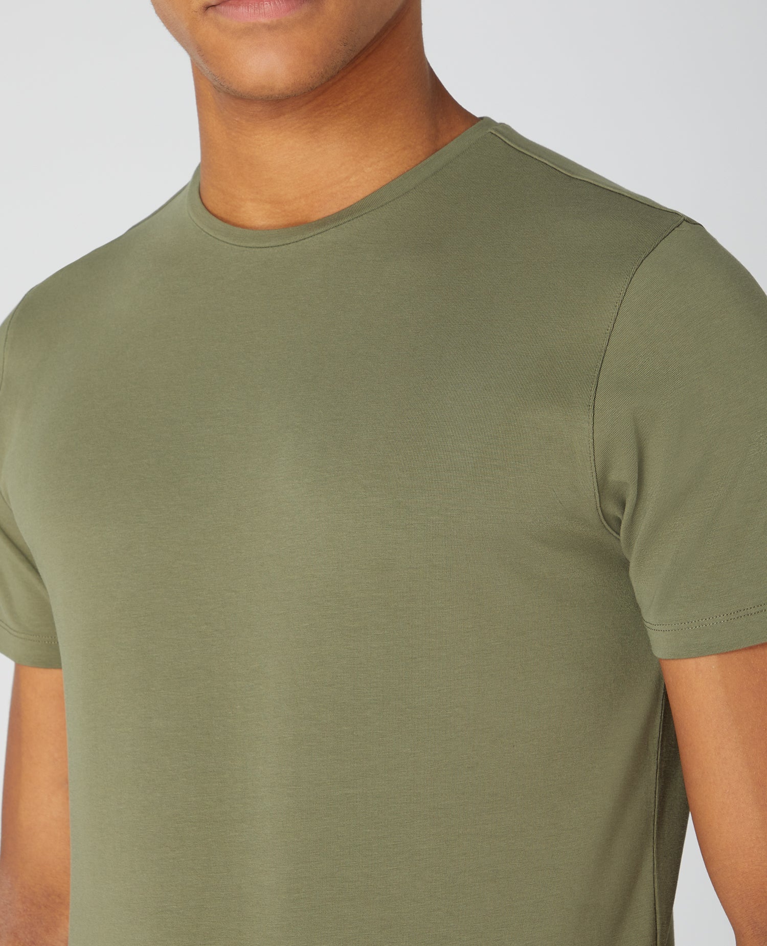 Man wearing a green Tapered Fit Cotton-Stretch T-Shirt