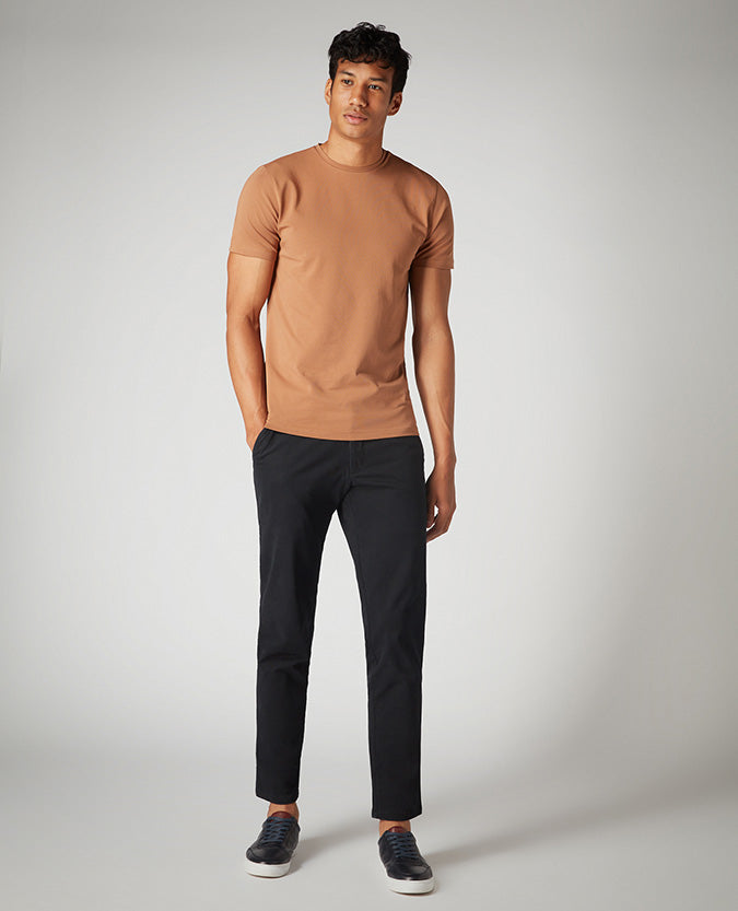 Man wearing a brown Tapered Fit Cotton-Stretch T-Shirt