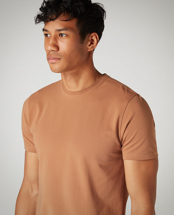 Man wearing a brown Tapered Fit Cotton-Stretch T-Shirt