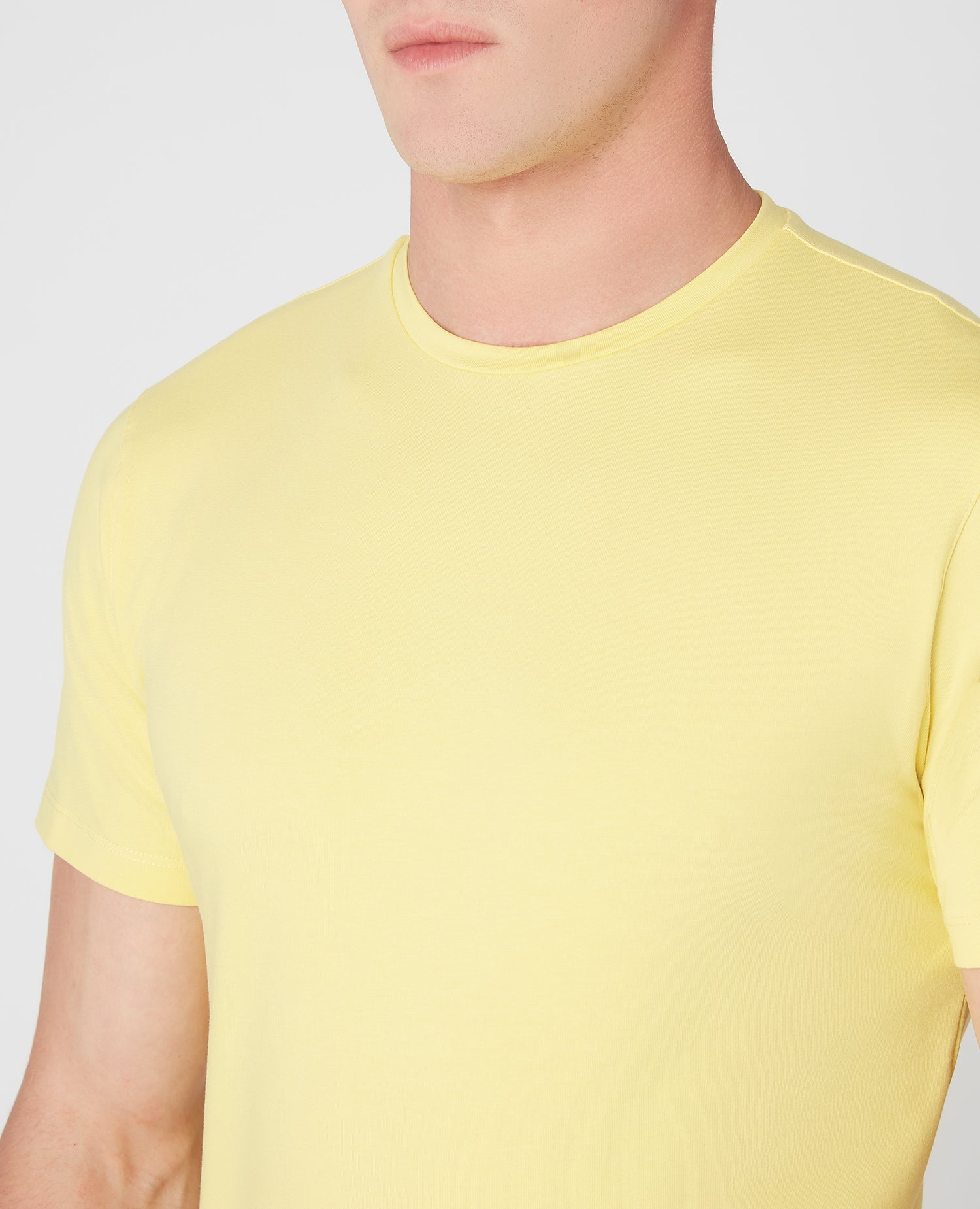 Man wearing a orange Tapered Fit Cotton-Stretch T-Shirt
