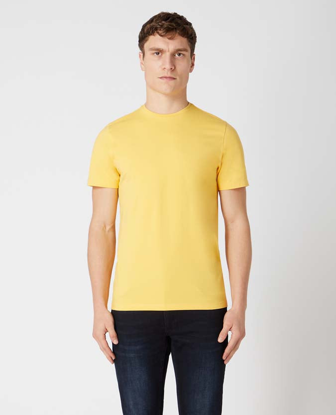 Man wearing a orange Tapered Fit Cotton-Stretch T-Shirt