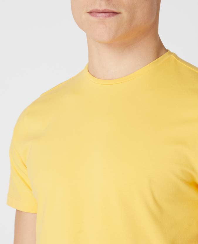 Man wearing a orange Tapered Fit Cotton-Stretch T-Shirt