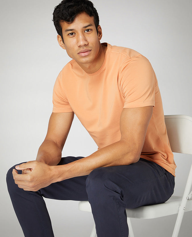 Man wearing a orange Tapered Fit Cotton-Stretch T-Shirt