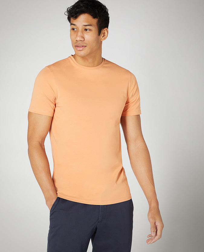 Man wearing a orange Tapered Fit Cotton-Stretch T-Shirt