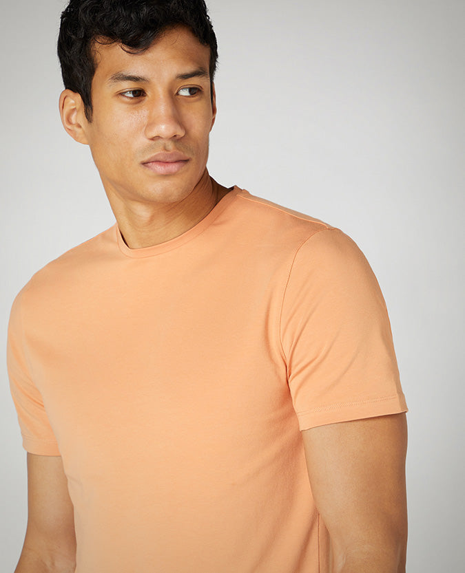 Man wearing a orange Tapered Fit Cotton-Stretch T-Shirt