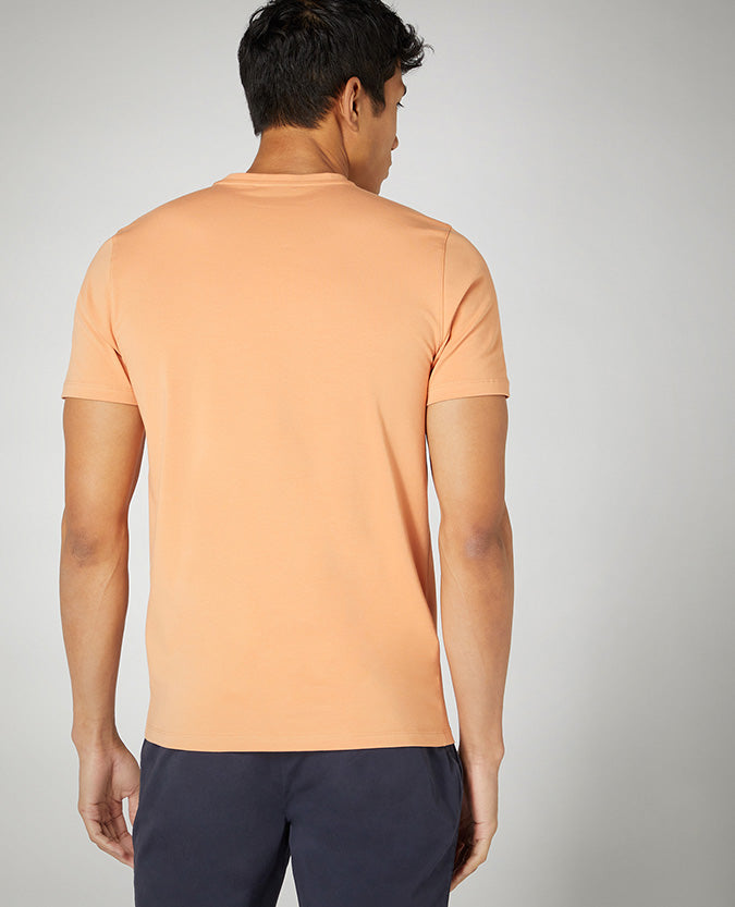 Man wearing a orange Tapered Fit Cotton-Stretch T-Shirt