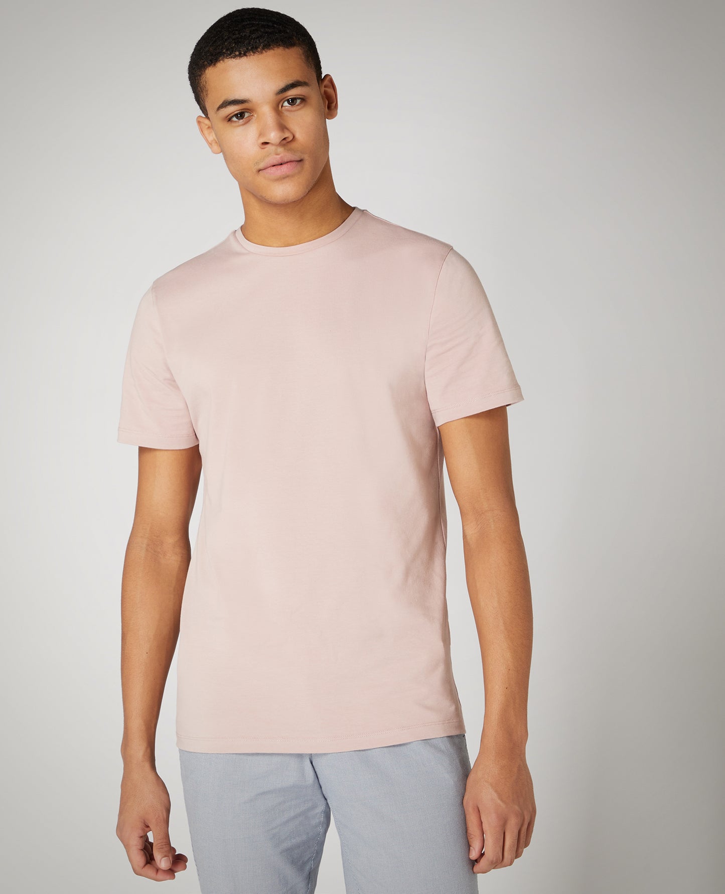 Man wearing a pink Tapered Fit Cotton-Stretch T-Shirt