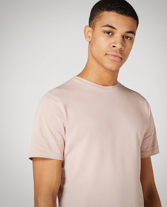 Man wearing a pink Tapered Fit Cotton-Stretch T-Shirt