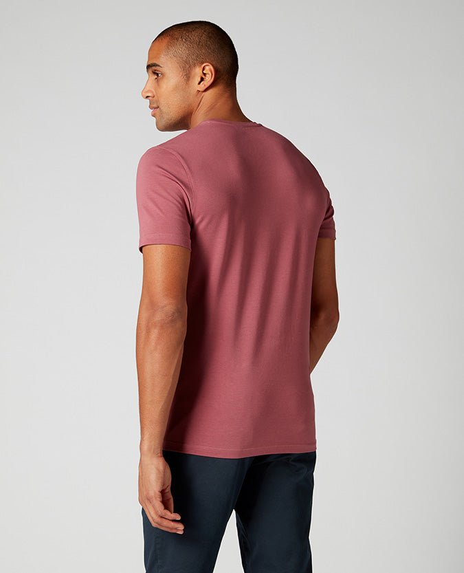 Man wearing a red Tapered Fit Cotton-Stretch T-Shirt