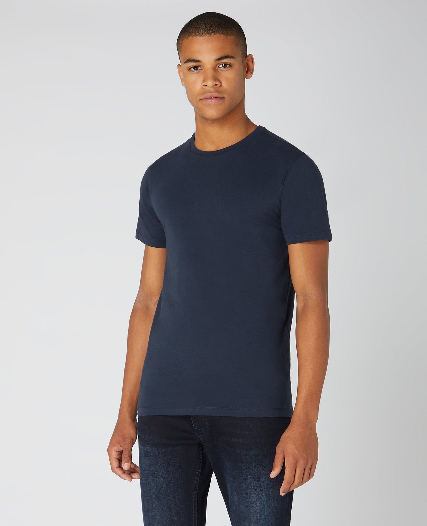Man wearing a navy Tapered Fit Cotton-Stretch T-Shirt
