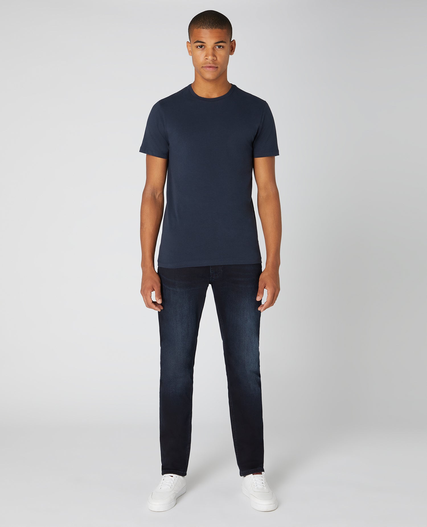 Man wearing a navy Tapered Fit Cotton-Stretch T-Shirt