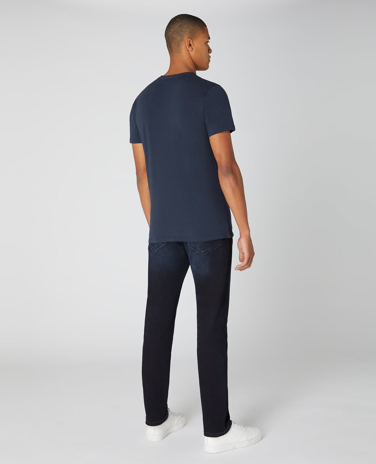 Man wearing a navy Tapered Fit Cotton-Stretch T-Shirt