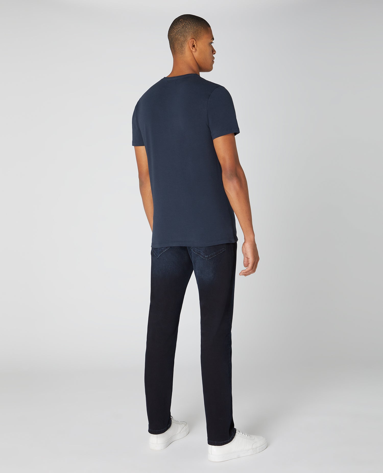 Man wearing a navy Tapered Fit Cotton-Stretch T-Shirt