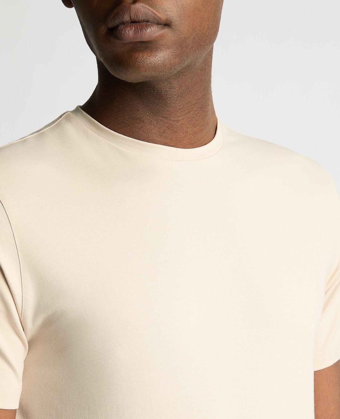 Man wearing a sand Tapered Fit Cotton-Stretch T-Shirt