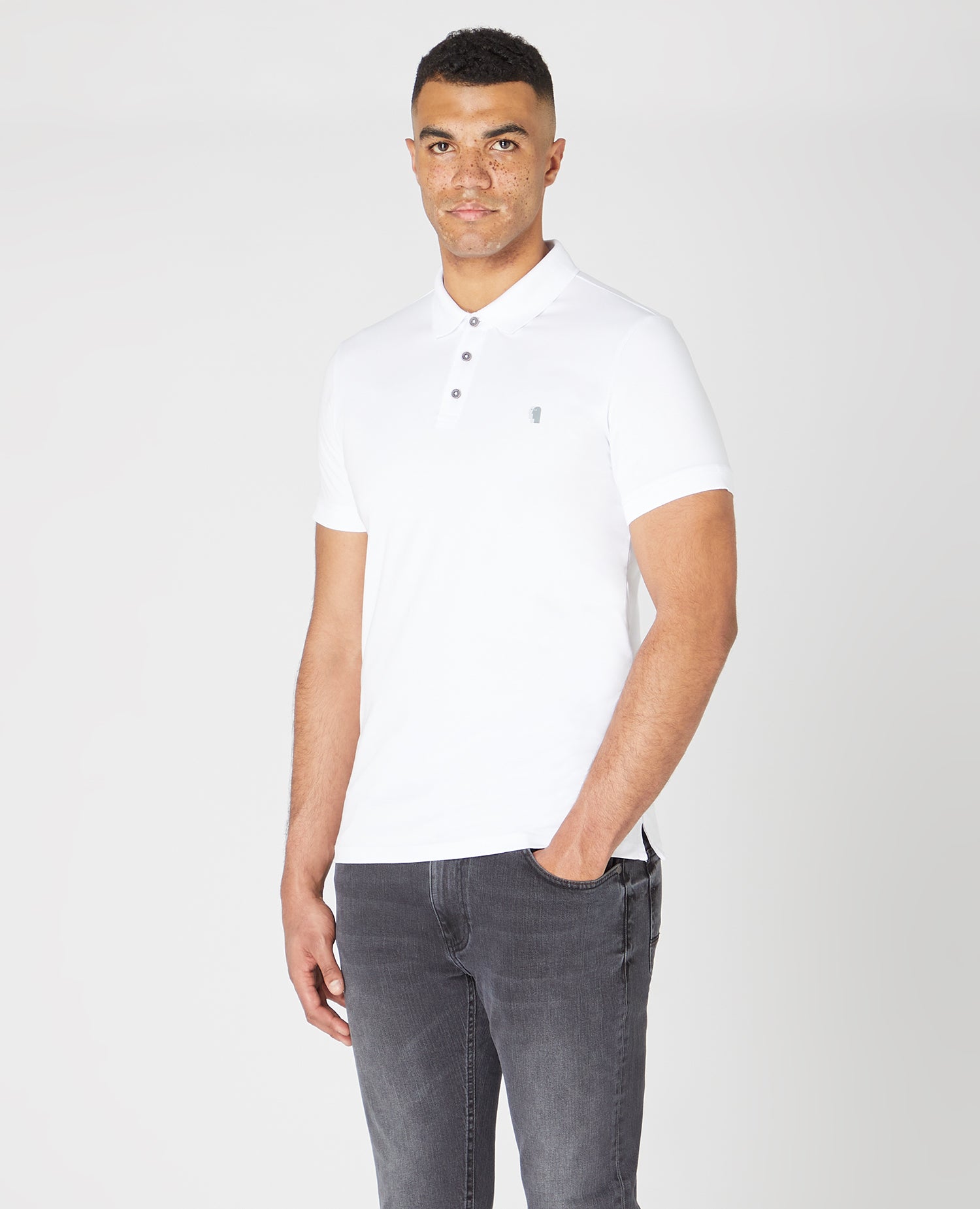 Man wearing a white Tapered Fit Cotton-Stretch Polo Shirt