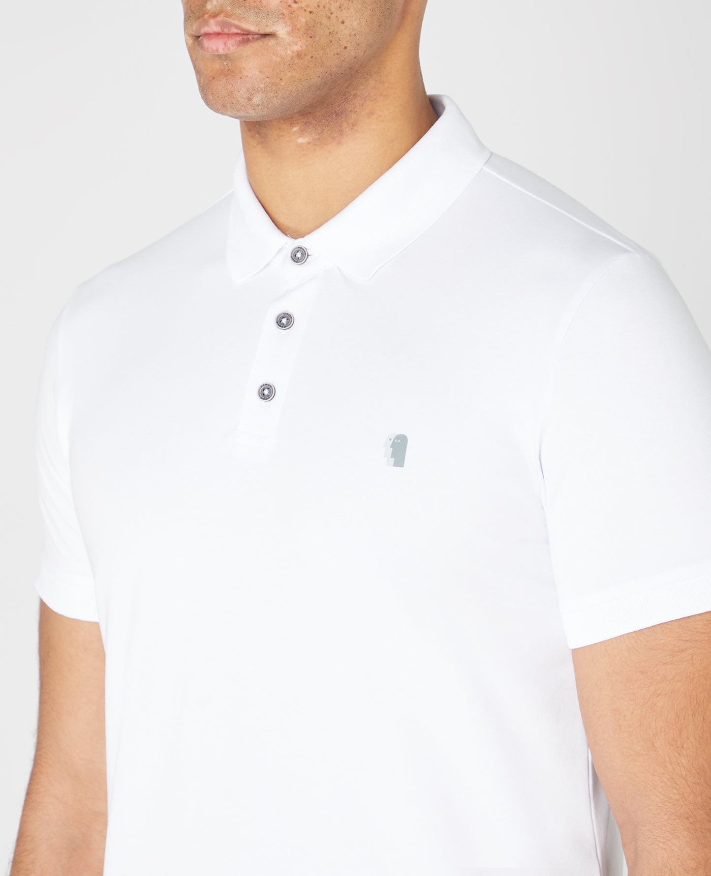 Man wearing a white Tapered Fit Cotton-Stretch Polo Shirt