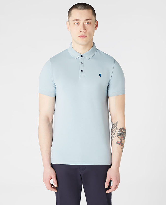 Man wearing a blue Tapered Fit Cotton-Blend Stretch Polo Shirt