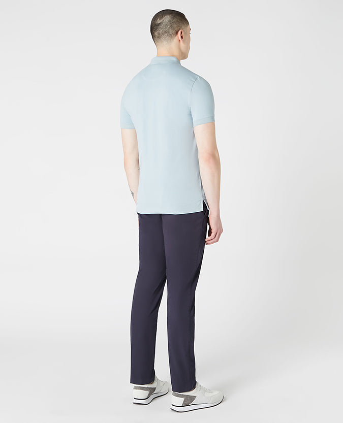 Man wearing a blue Tapered Fit Cotton-Blend Stretch Polo Shirt