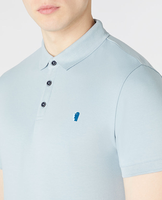Man wearing a blue Tapered Fit Cotton-Blend Stretch Polo Shirt