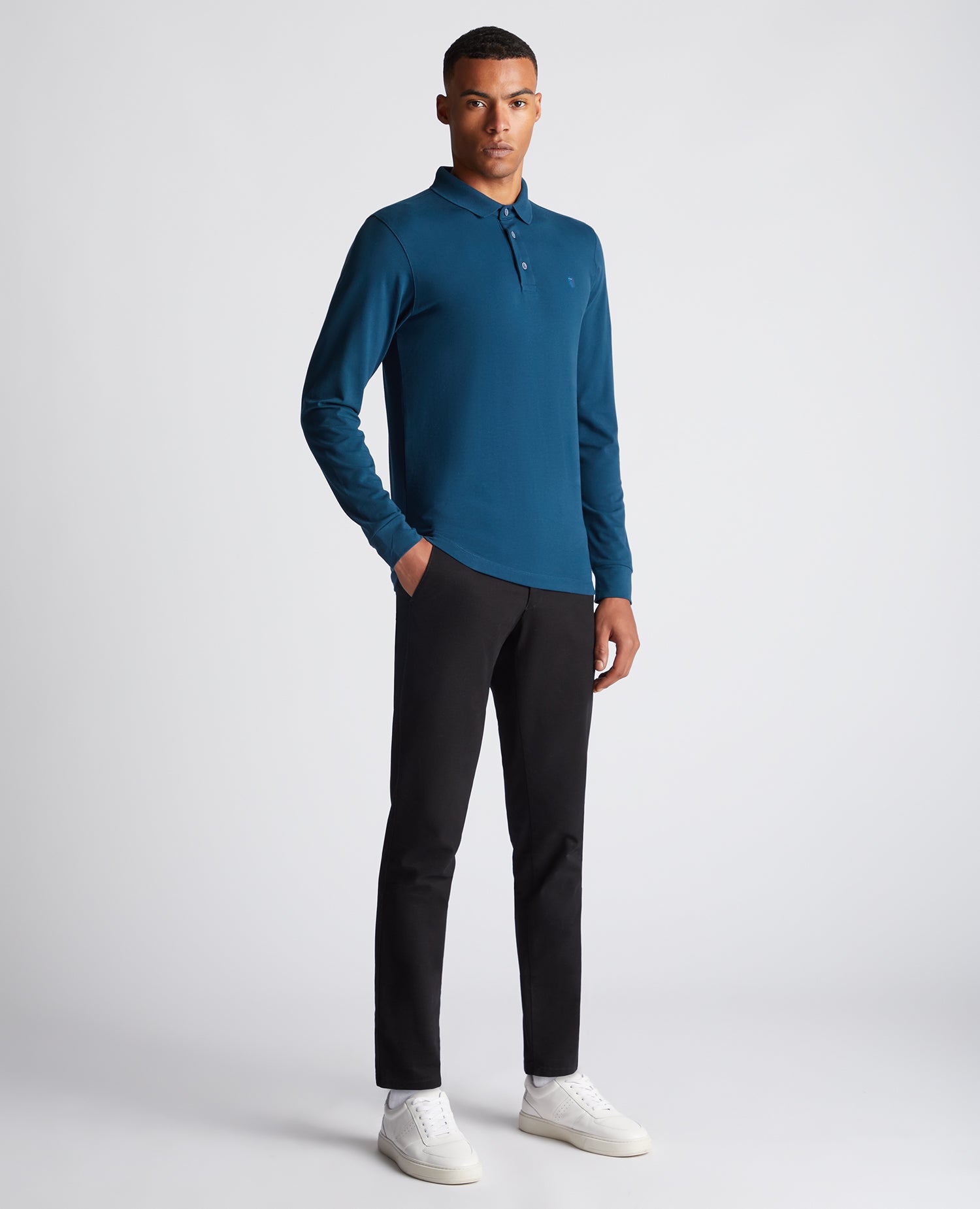 Man wearing a blue Tapered Fit Cotton-Stretch Long-Sleeve Polo Shirt