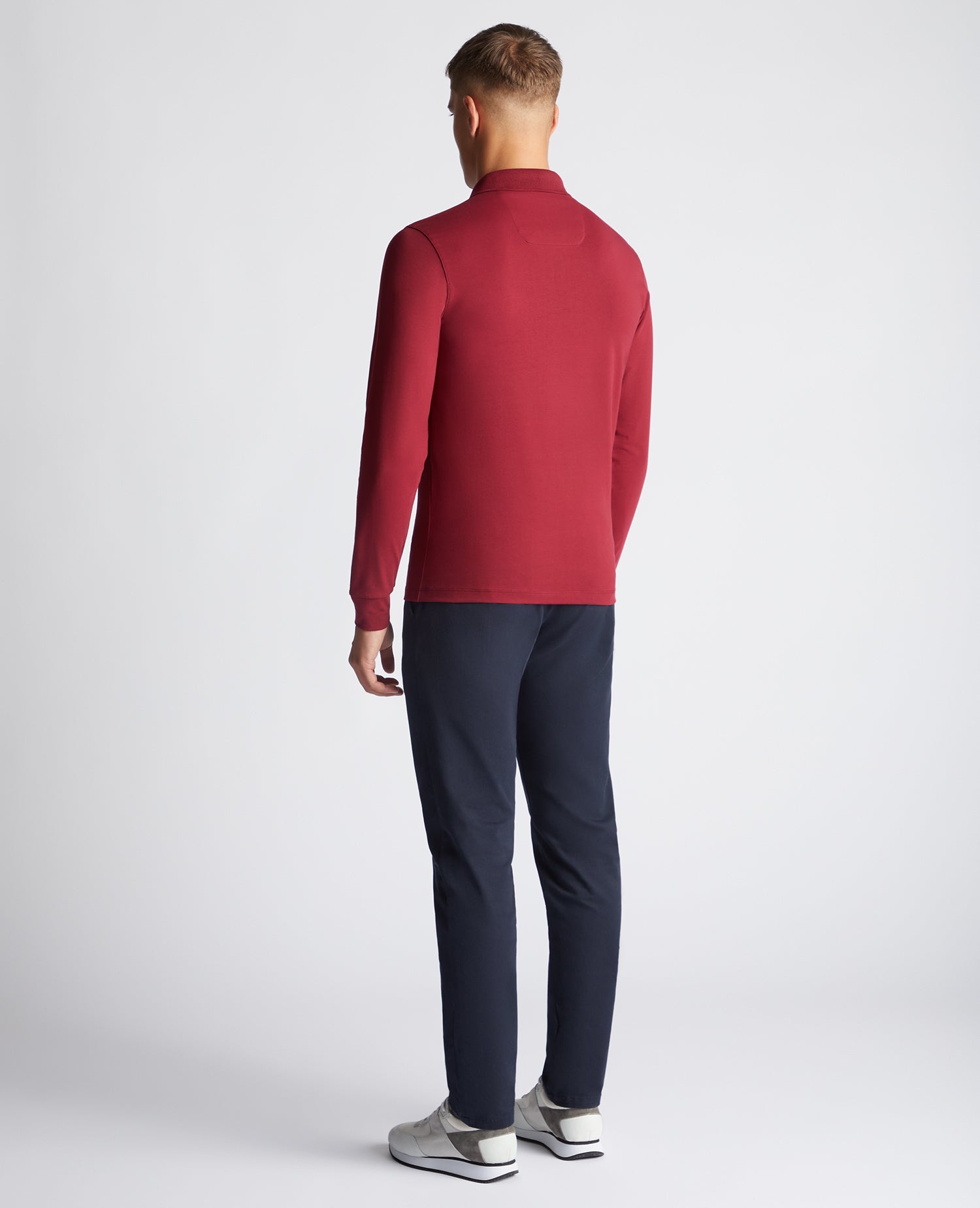 Man wearing a red Tapered Fit Cotton-Stretch Long-Sleeve Polo Shirt