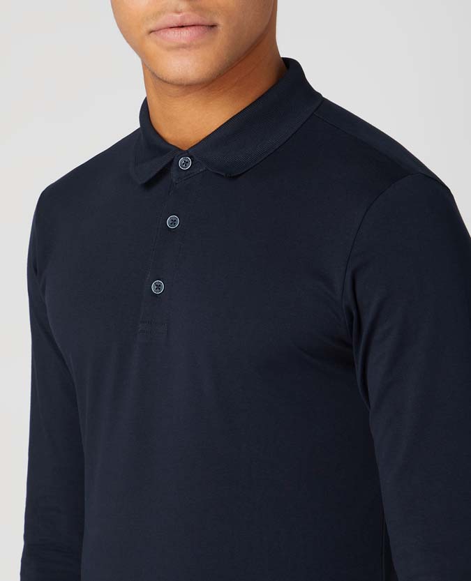Man wearing a navy Tapered Fit Cotton-Stretch Long-Sleeve Polo Shirt
