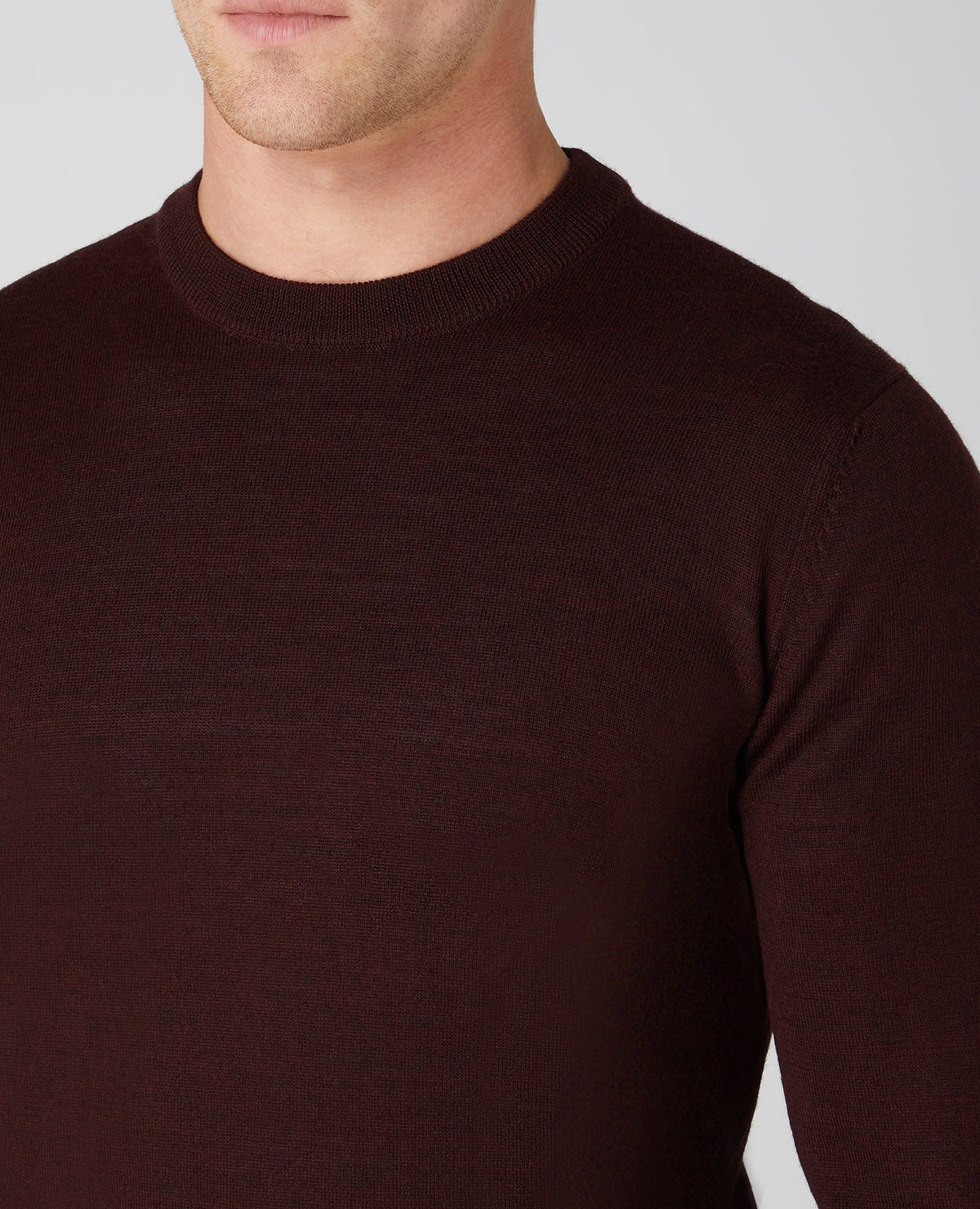Man wearing a red Tapered Fit Merino Wool-Blend Crew Neck Sweater