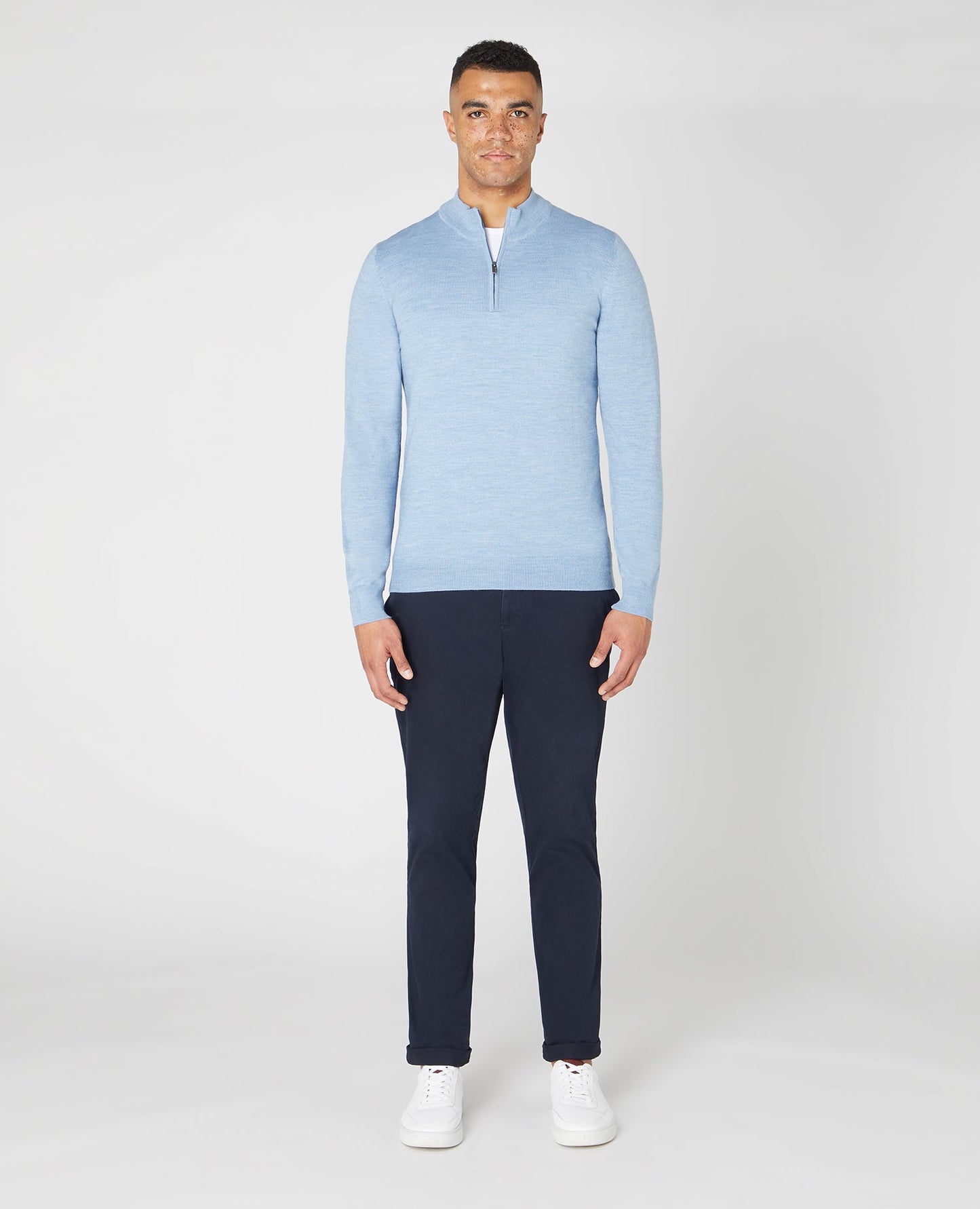 Man wearing a blue Tapered fit Merino Wool Half Zip Sweater