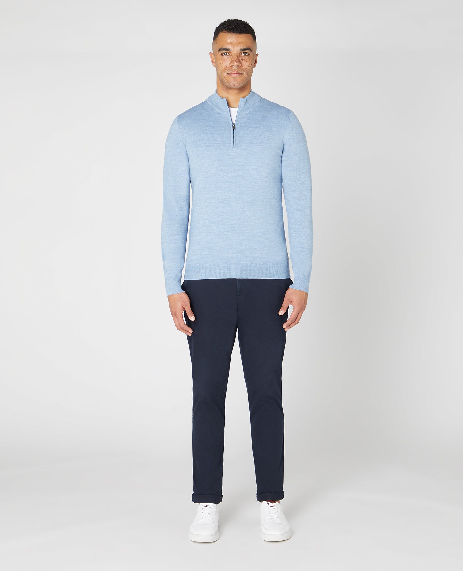 Man wearing a blue Tapered fit Merino Wool Half Zip Sweater