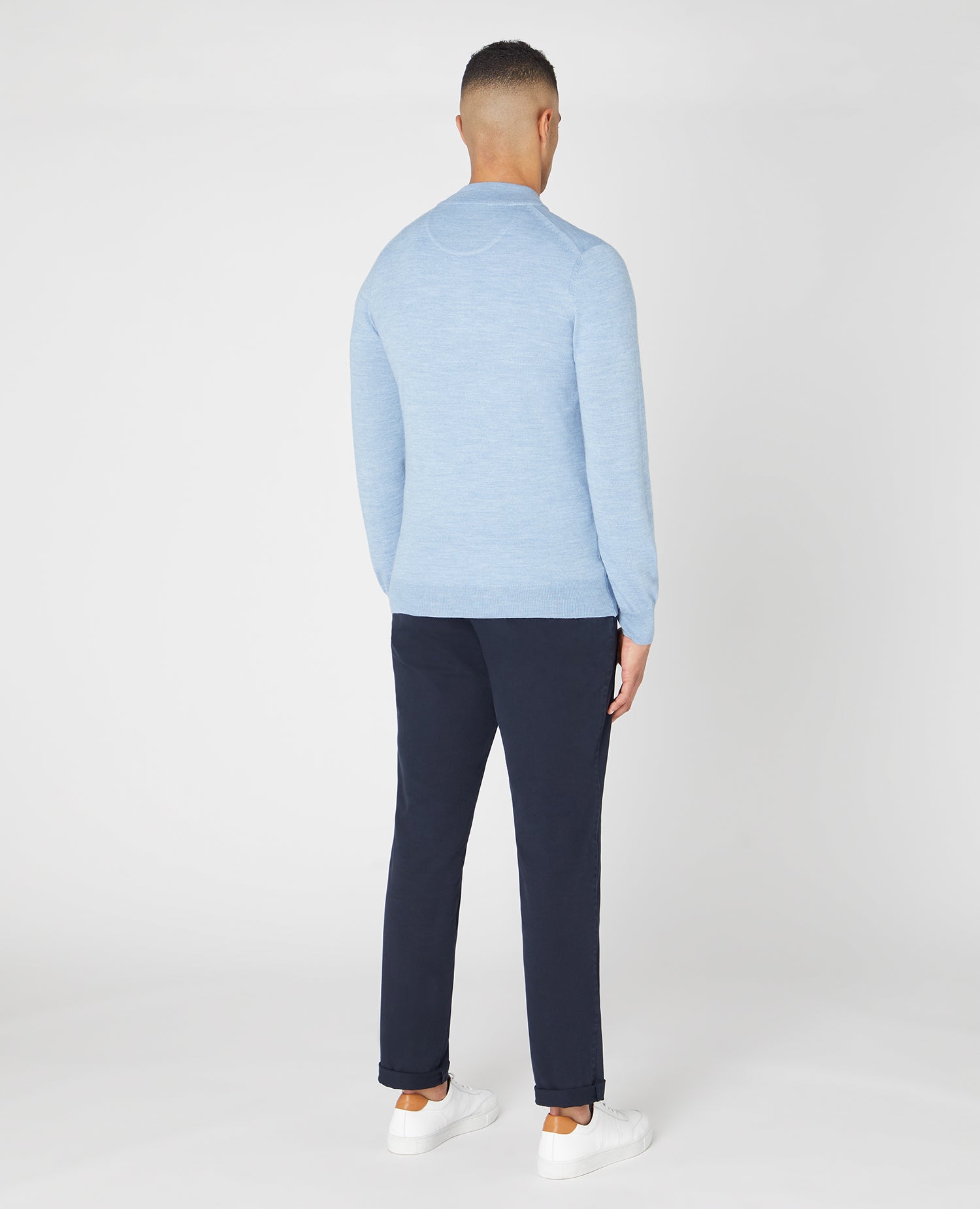 Man wearing a blue Tapered fit Merino Wool Half Zip Sweater