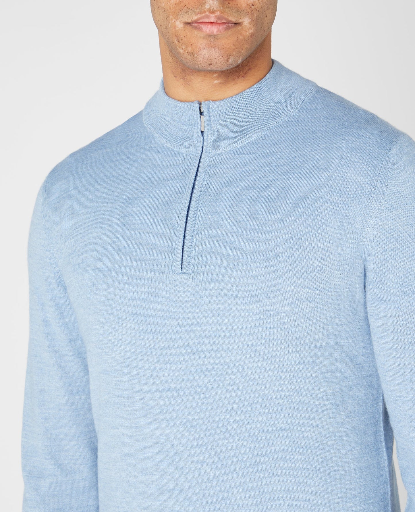 Man wearing a blue Tapered fit Merino Wool Half Zip Sweater